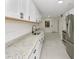 Updated kitchen featuring white cabinets, granite countertops, and stainless steel appliances at 1234 Lynwood Ave, Apopka, FL 32703