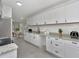 Beautiful kitchen featuring white cabinetry, granite counters, and modern stainless appliances at 1234 Lynwood Ave, Apopka, FL 32703