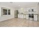 Bright kitchen features stainless steel appliances, granite countertops, and tile flooring at 1234 Lynwood Ave, Apopka, FL 32703