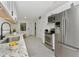 Modern kitchen with stainless steel appliances, white cabinets, and granite countertops at 1234 Lynwood Ave, Apopka, FL 32703