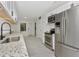 Modern kitchen with stainless steel appliances, white cabinets, and granite countertops at 1234 Lynwood Ave, Apopka, FL 32703