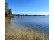 Clear water lake access with a dock and sandy bottom at 1234 Lynwood Ave, Apopka, FL 32703