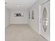 Bright, open living room with tile floors and ample natural light from multiple windows at 1234 Lynwood Ave, Apopka, FL 32703