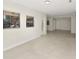 Bright living area showcasing a decorative entry door and open floor plan to the dining area at 1234 Lynwood Ave, Apopka, FL 32703