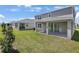 Exterior backyard with covered patio and well-maintained lawn at 1698 Sugarbelle Cir, Mascotte, FL 34753