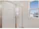Bathroom featuring a glass-enclosed shower with white tile surround and a bright, airy window at 1698 Sugarbelle Cir, Mascotte, FL 34753