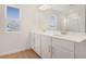 Bathroom featuring a double sink vanity, modern lighting, and a glass enclosed shower at 1698 Sugarbelle Cir, Mascotte, FL 34753