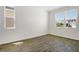 Bright bedroom with wood-look tile flooring and lots of natural light from large windows at 1698 Sugarbelle Cir, Mascotte, FL 34753