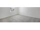 Bedroom with carpet, neutral walls, and a window overlooking the side yard at 1698 Sugarbelle Cir, Mascotte, FL 34753
