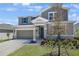 Beautiful two-story home with attached two car garage and manicured front lawn at 1698 Sugarbelle Cir, Mascotte, FL 34753