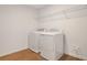 Bright laundry room featuring new washer, dryer, tile flooring, and wire rack shelving at 1698 Sugarbelle Cir, Mascotte, FL 34753