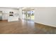 Open floor plan leading to kitchen with sliding glass doors and wood look tile at 1698 Sugarbelle Cir, Mascotte, FL 34753