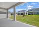 An inviting covered patio with a view of the well-maintained backyard and neighboring homes at 1698 Sugarbelle Cir, Mascotte, FL 34753