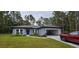 Newly built home with a gray exterior, two-car garage, and landscaped front yard at 6817 Sw 131St Pl, Ocala, FL 34473