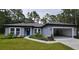 Single story home with gray exterior, two car garage and landscaping at 6817 Sw 131St Pl, Ocala, FL 34473