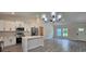 Open concept kitchen with white cabinets and a large island at 6817 Sw 131St Pl, Ocala, FL 34473