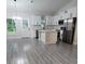 Modern kitchen with white cabinets, stainless steel appliances, and an island at 6817 Sw 131St Pl, Ocala, FL 34473
