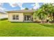 The house has a well-maintained yard with green grass and palm trees at 753 Largo Pass, Poinciana, FL 34759