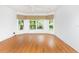 Spacious room with hardwood flooring, white walls, and a large window at 753 Largo Pass, Poinciana, FL 34759
