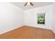 Bedroom with a ceiling fan, wood floors, and a bright window at 753 Largo Pass, Poinciana, FL 34759