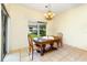Dining area features tile flooring, a wood table with chairs, and natural lighting at 753 Largo Pass, Poinciana, FL 34759