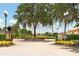 Stonegate Golf Club entrance with manicured landscaping and mature trees at 753 Largo Pass, Poinciana, FL 34759