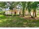 Inviting single-Gathering home featuring lush landscaping, mature trees, and a cozy front porch at 753 Largo Pass, Poinciana, FL 34759