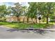 Attractive home featuring mature landscaping, a well-kept lawn, and a paved street at 753 Largo Pass, Poinciana, FL 34759
