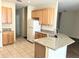 Bright kitchen featuring wooden cabinets, granite countertops, stainless steel appliances, and an eat-in island at 753 Largo Pass, Poinciana, FL 34759