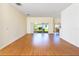 Bright living room with wood-look flooring and sliding glass doors to the backyard at 753 Largo Pass, Poinciana, FL 34759