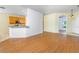 Open-concept living area with laminate flooring and a view of the kitchen at 753 Largo Pass, Poinciana, FL 34759