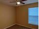 Bedroom featuring a ceiling fan, large window providing natural light at 8830 Dunes Ct # 12 207, Kissimmee, FL 34747