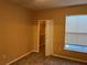 Carpeted bedroom with a closet and window at 8830 Dunes Ct # 12 207, Kissimmee, FL 34747