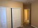 Bedroom showing the closet and view into the hallway at 8830 Dunes Ct # 12 207, Kissimmee, FL 34747