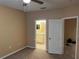 Bedroom with ceiling fan and entryways to an ensuite bathroom and additional closet at 8830 Dunes Ct # 12 207, Kissimmee, FL 34747