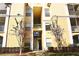 Exterior of tan colored building with outdoor staircase and pedestrian access to upper floors at 8830 Dunes Ct # 12 207, Kissimmee, FL 34747