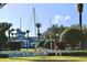 Legacy Dunes sign with view of clubhouse and manicured landscaping at 8830 Dunes Ct # 12 207, Kissimmee, FL 34747