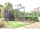 A golf hitting cage structure on a bright, sunny day at 8830 Dunes Ct # 12 207, Kissimmee, FL 34747