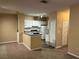 Bright kitchen features white cabinets, grey counters, and sleek appliances at 8830 Dunes Ct # 12 207, Kissimmee, FL 34747