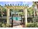 Gated entrance to the community pool area with clear signage and manicured landscaping at 8830 Dunes Ct # 12 207, Kissimmee, FL 34747