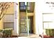 A close up of the building's outdoor staircase used to access the upper floor units at 8830 Dunes Ct # 12 207, Kissimmee, FL 34747