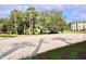 Sand volleyball court in community, surrounded by trees and grass, with volleyball net at 8830 Dunes Ct # 12 207, Kissimmee, FL 34747