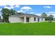 House with a grassy backyard and covered patio at 314 Dagama Ct, Kissimmee, FL 34758