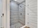 Modern bathroom featuring a tiled walk-in shower with a pebble floor at 314 Dagama Ct, Kissimmee, FL 34758