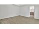 A bright bedroom with neutral walls, tile floors, and an open doorway to the bathroom at 314 Dagama Ct, Kissimmee, FL 34758