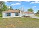 Inviting single-story home featuring a manicured lawn, white exterior, and a two-car garage at 314 Dagama Ct, Kissimmee, FL 34758