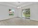 Bright living room with wood-look tile floors, sliding glass door, and large window overlooking the backyard at 314 Dagama Ct, Kissimmee, FL 34758