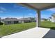 View of the backyard and surrounding houses in the neighborhood from the covered patio at 5414 Catmint Dr, Lake Hamilton, FL 33851