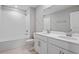 Well-lit bathroom with double vanity, a shower-tub combo and tile flooring at 5414 Catmint Dr, Lake Hamilton, FL 33851