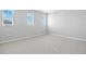 Neutral bedroom featuring gray carpet and ample natural light from three windows at 5414 Catmint Dr, Lake Hamilton, FL 33851